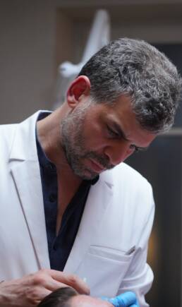 Dr Yoni Madar, chirurgien plasticien et esth&eacute;tique &agrave; Paris, en plein geste au cabinet